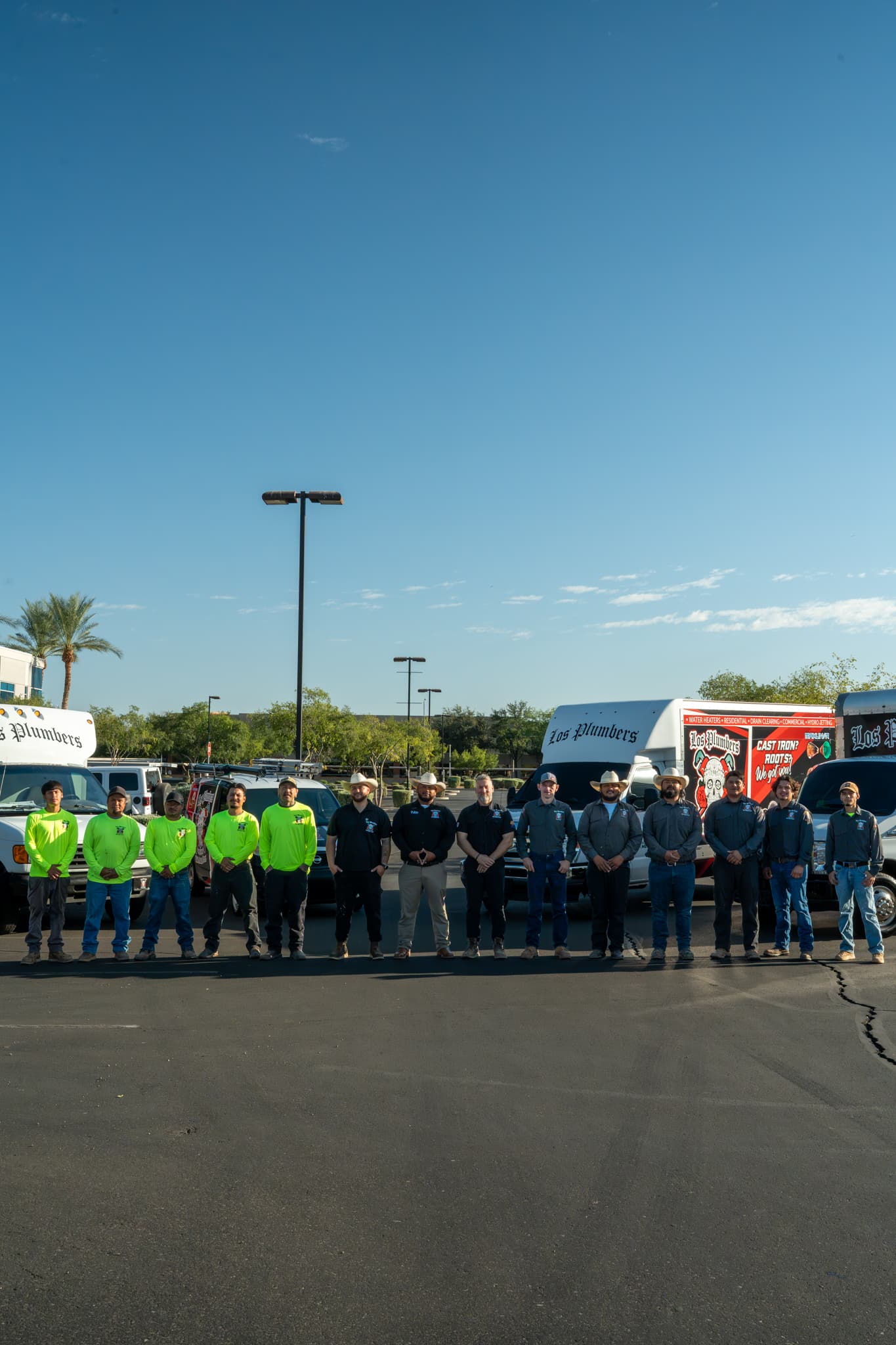The Los Plumbers crew lined up with the company fleet in Mesa, Arizona